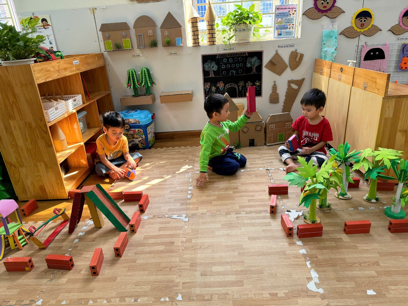 A group of kids playing with blocks

Description automatically generated