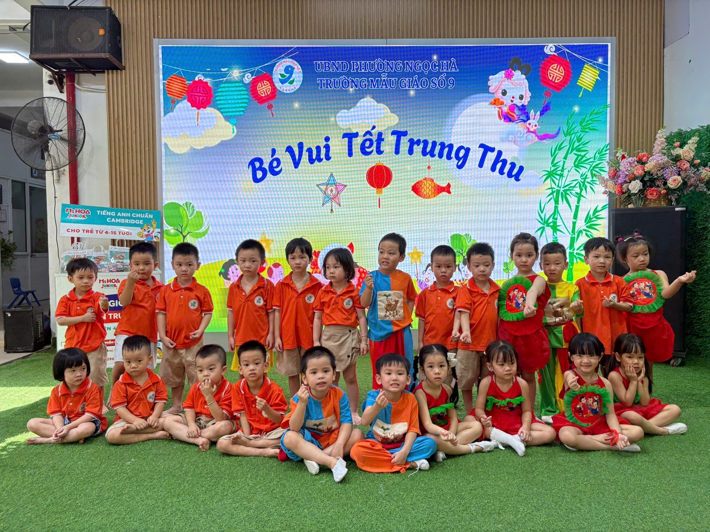 A group of children in orange shirts

AI-generated content may be incorrect.