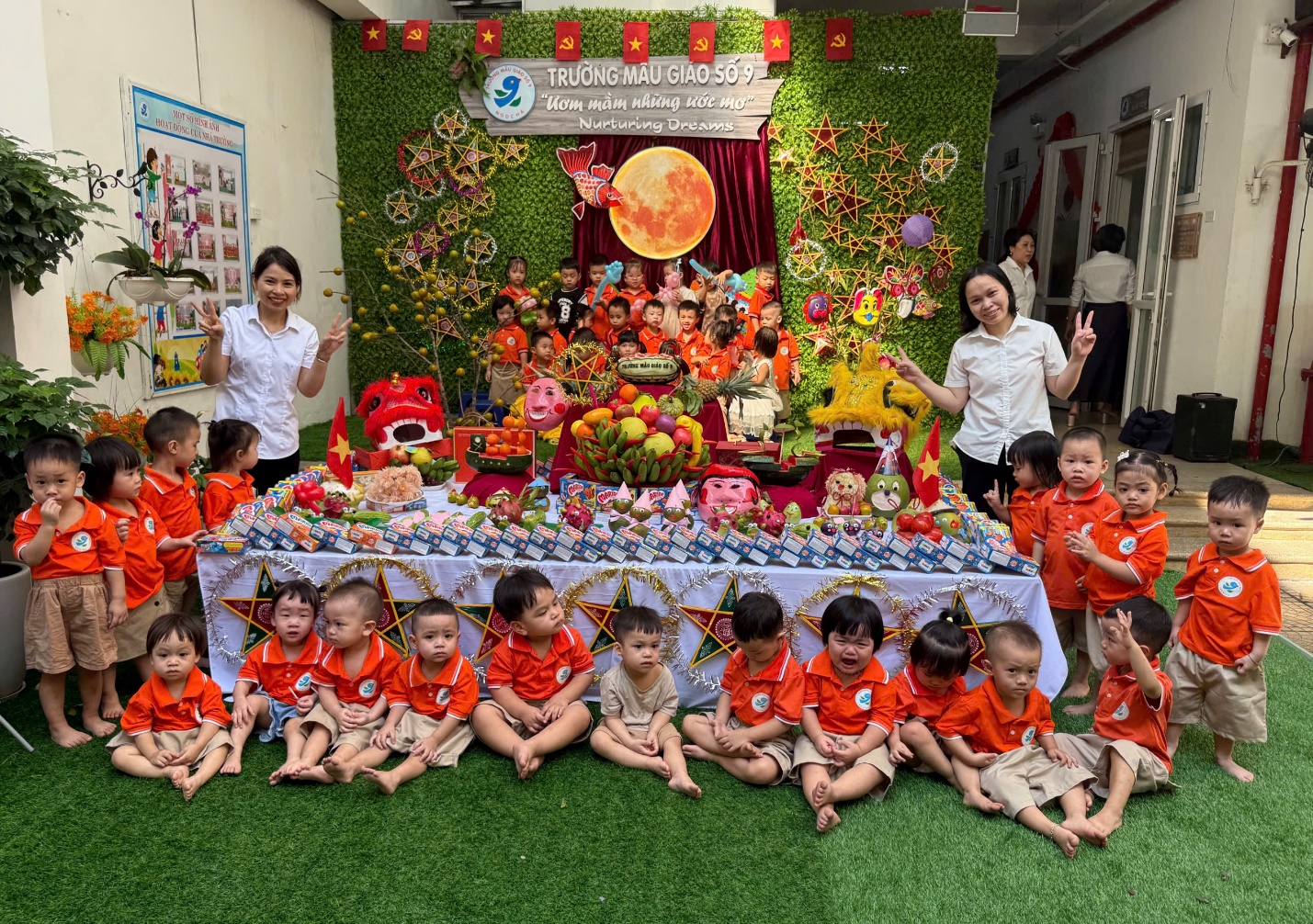 A group of children sitting on the ground in front of a table

AI-generated content may be incorrect.