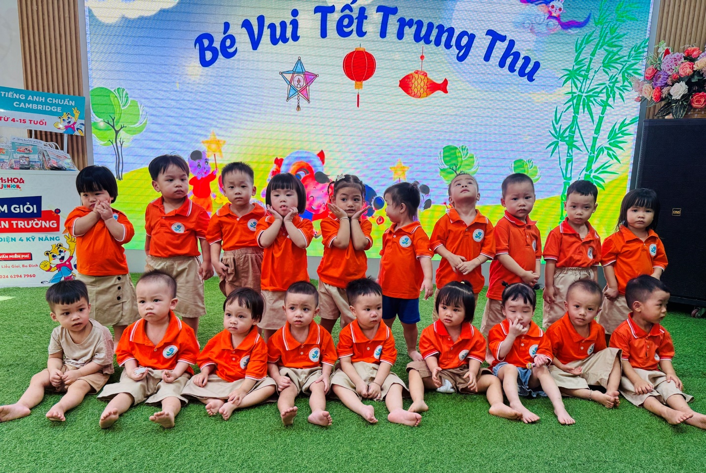 A group of children in orange shirts

AI-generated content may be incorrect.