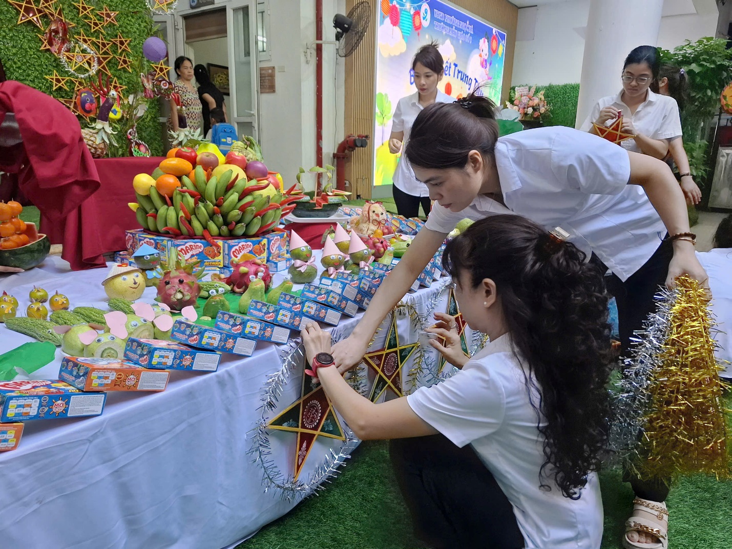 A group of women in a room with a table full of food

AI-generated content may be incorrect.
