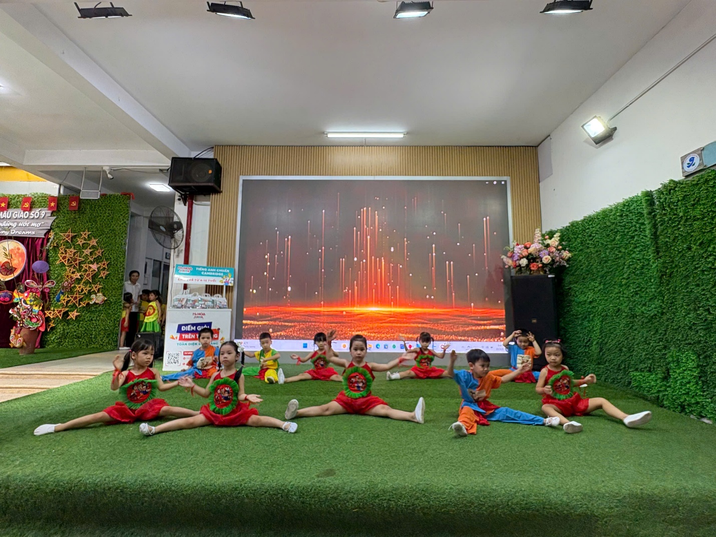 A group of kids sitting on a green surface

AI-generated content may be incorrect.