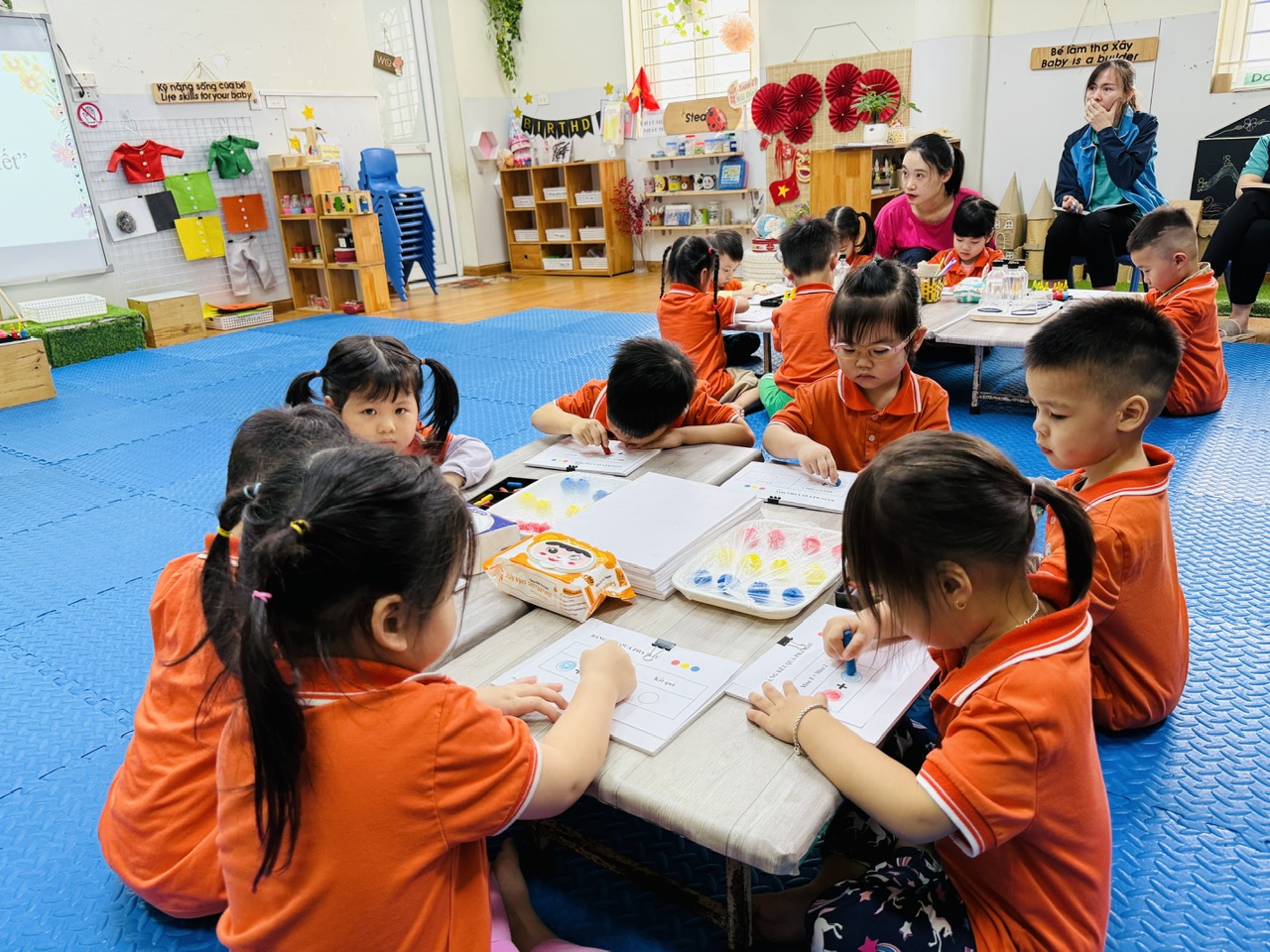 A group of children sitting at a table

AI-generated content may be incorrect.