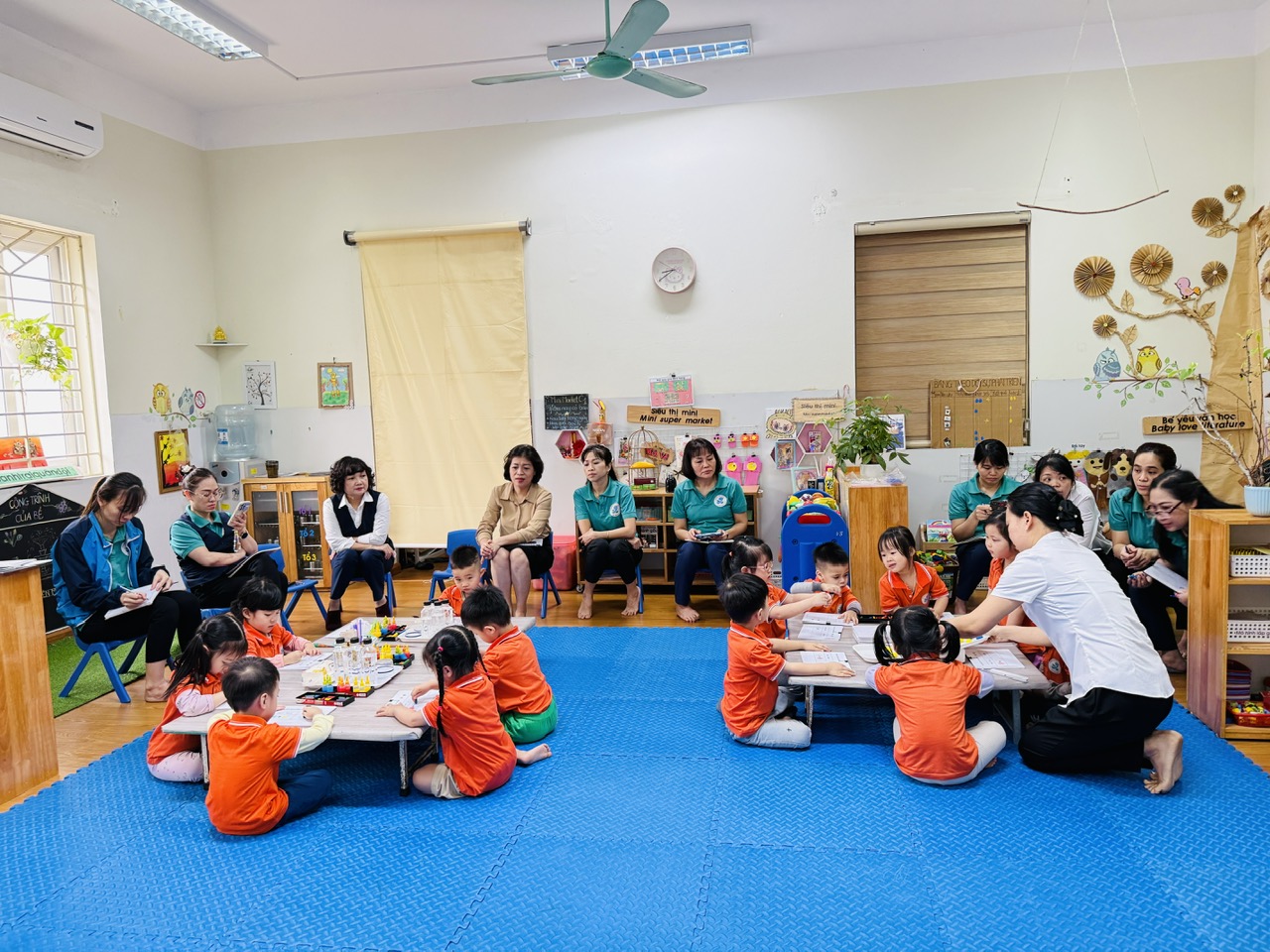 A group of children sitting on the floor in a room

AI-generated content may be incorrect.