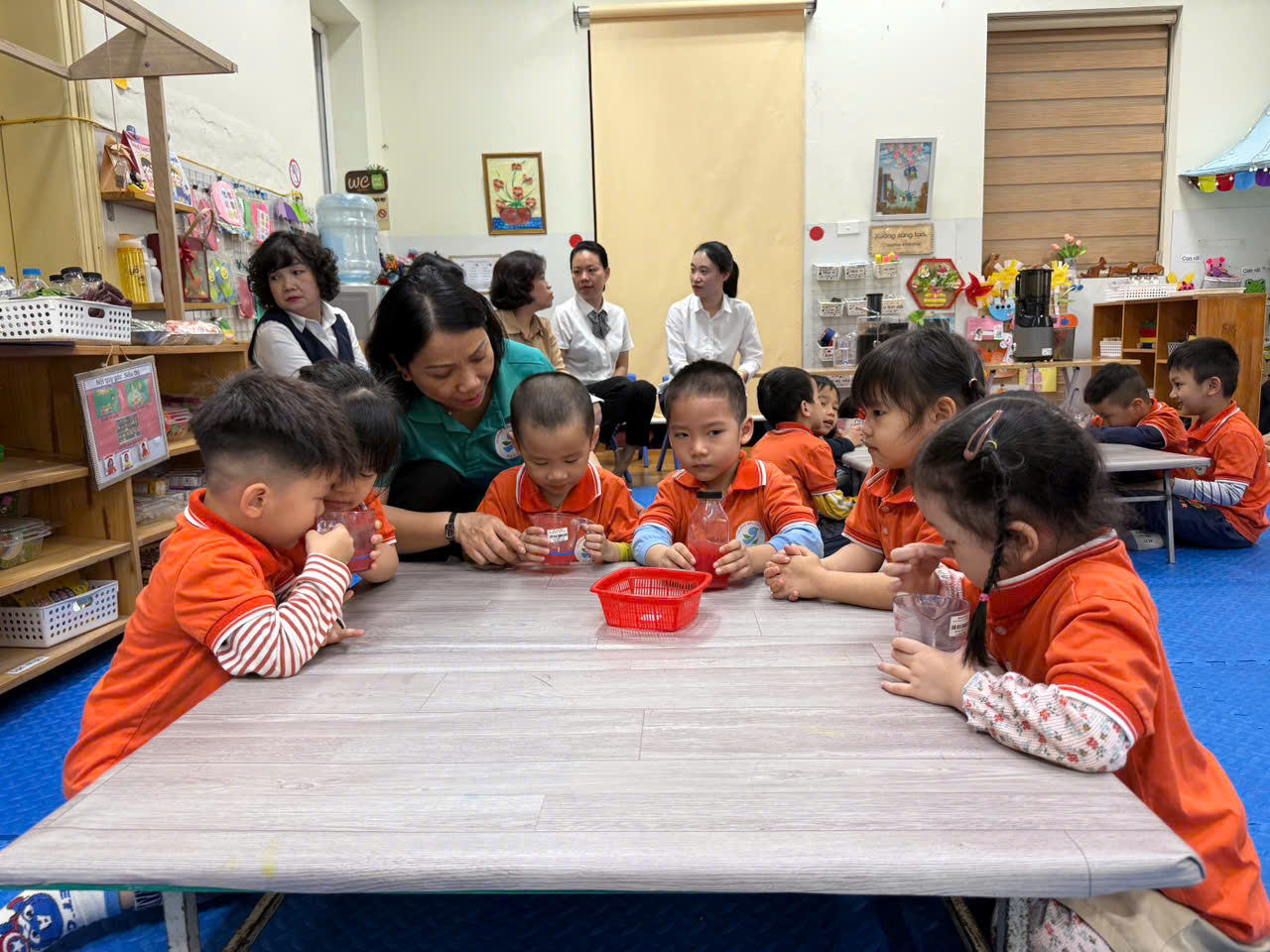 A group of children sitting at a table

AI-generated content may be incorrect.