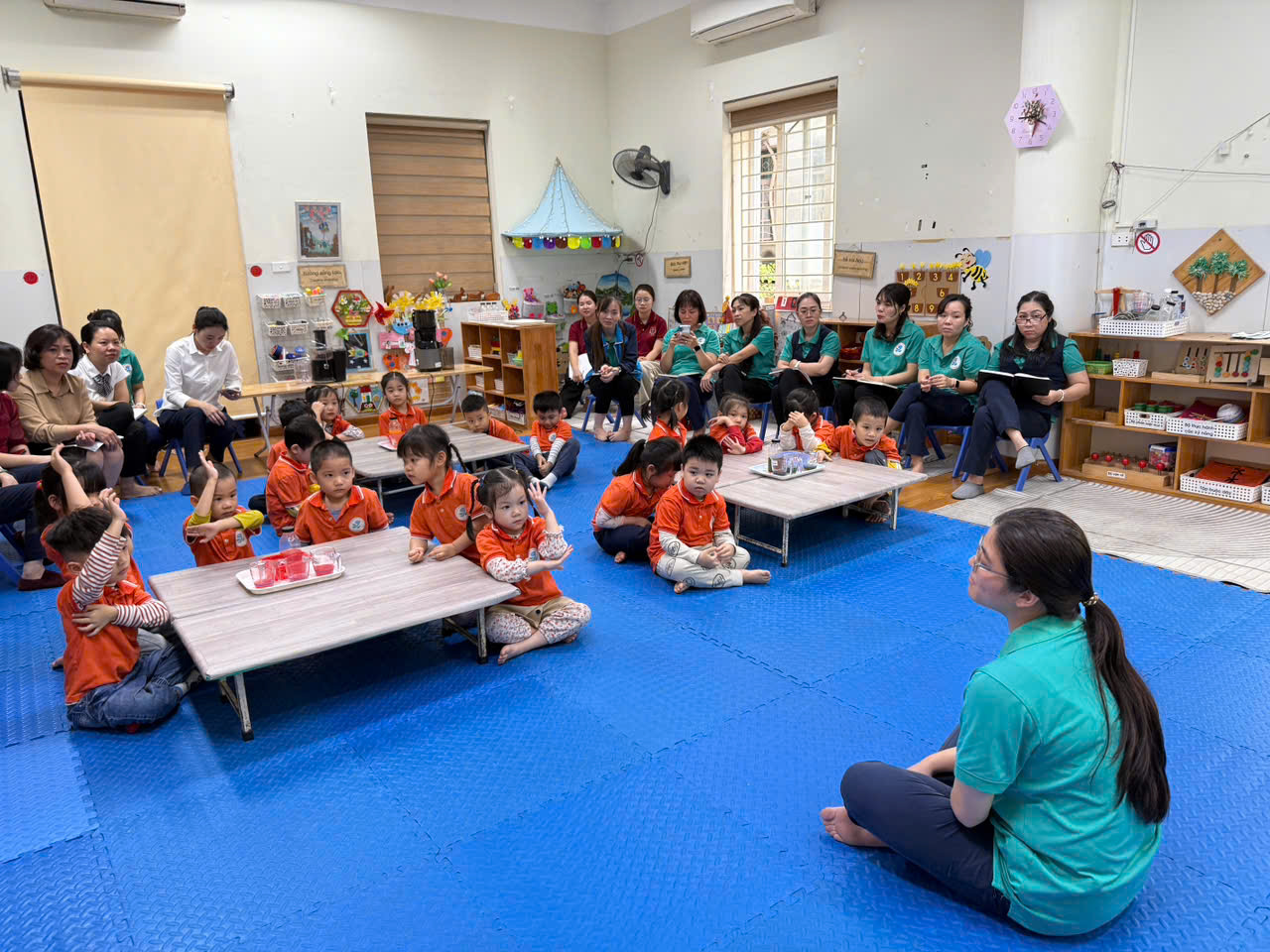 A group of children sitting on the floor in a classroom

AI-generated content may be incorrect.