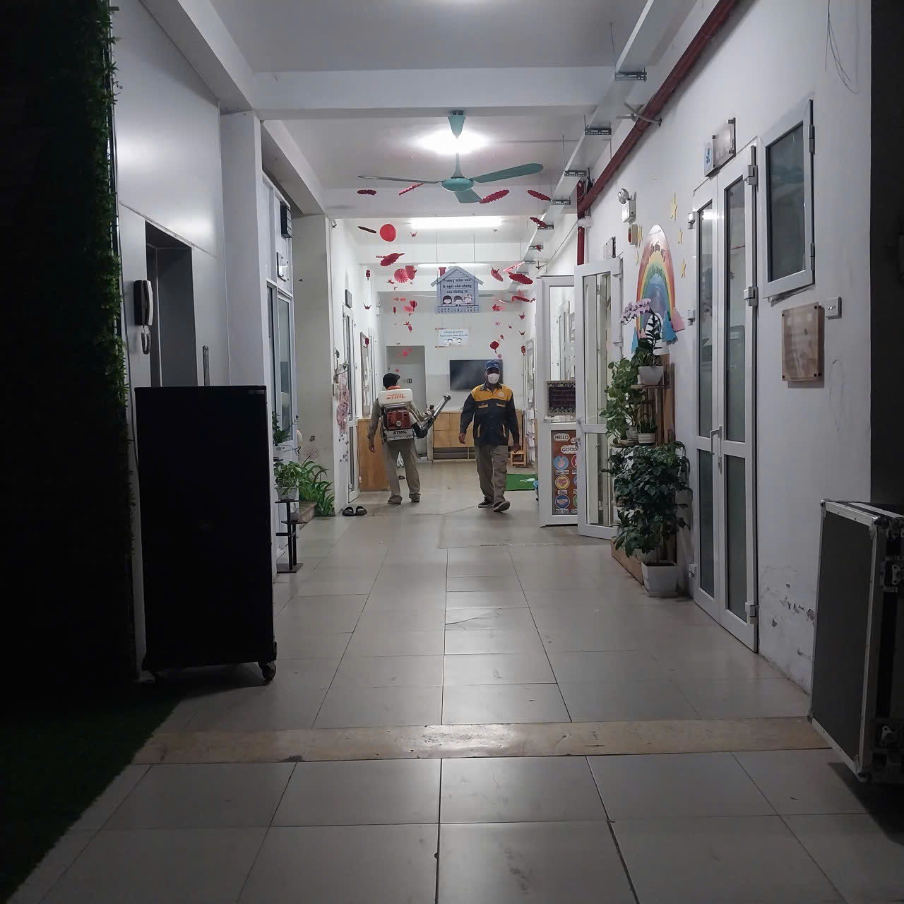 A hallway with people walking in it
AI-generated content may be incorrect.