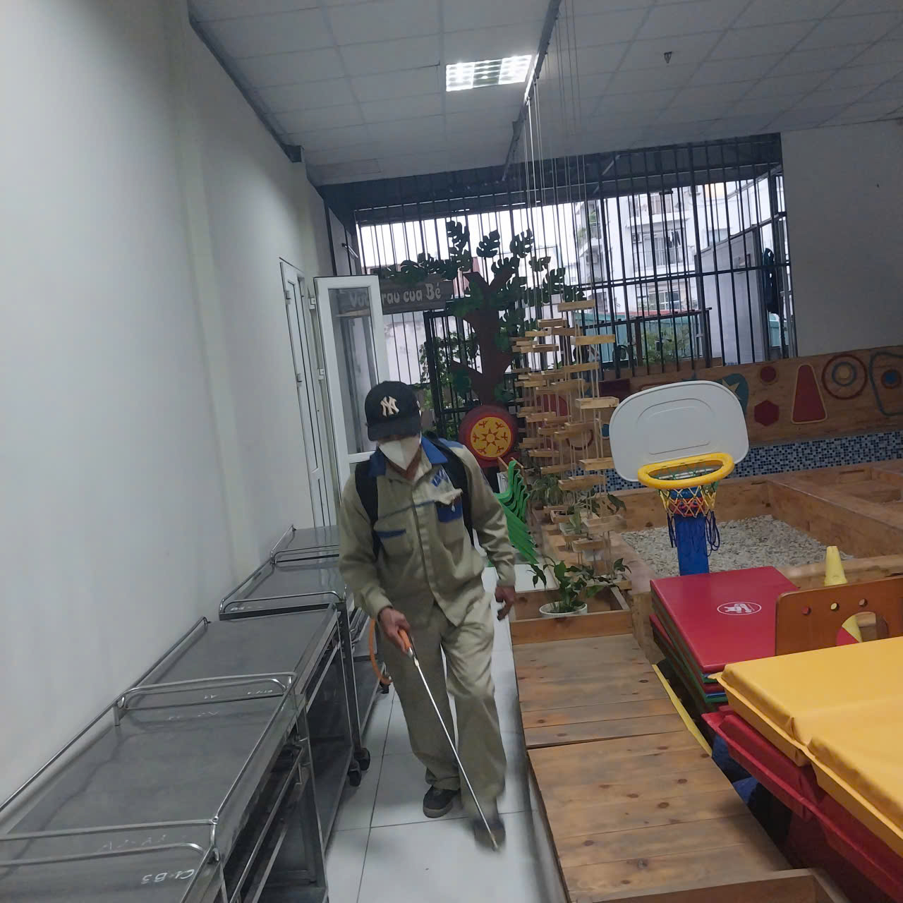 A person in a mask walking down a hallway
AI-generated content may be incorrect.