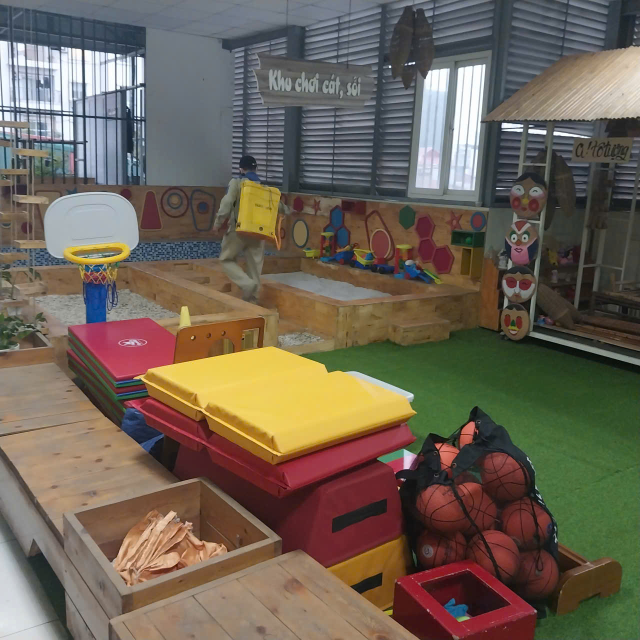 A room with a playground and a large window
AI-generated content may be incorrect.