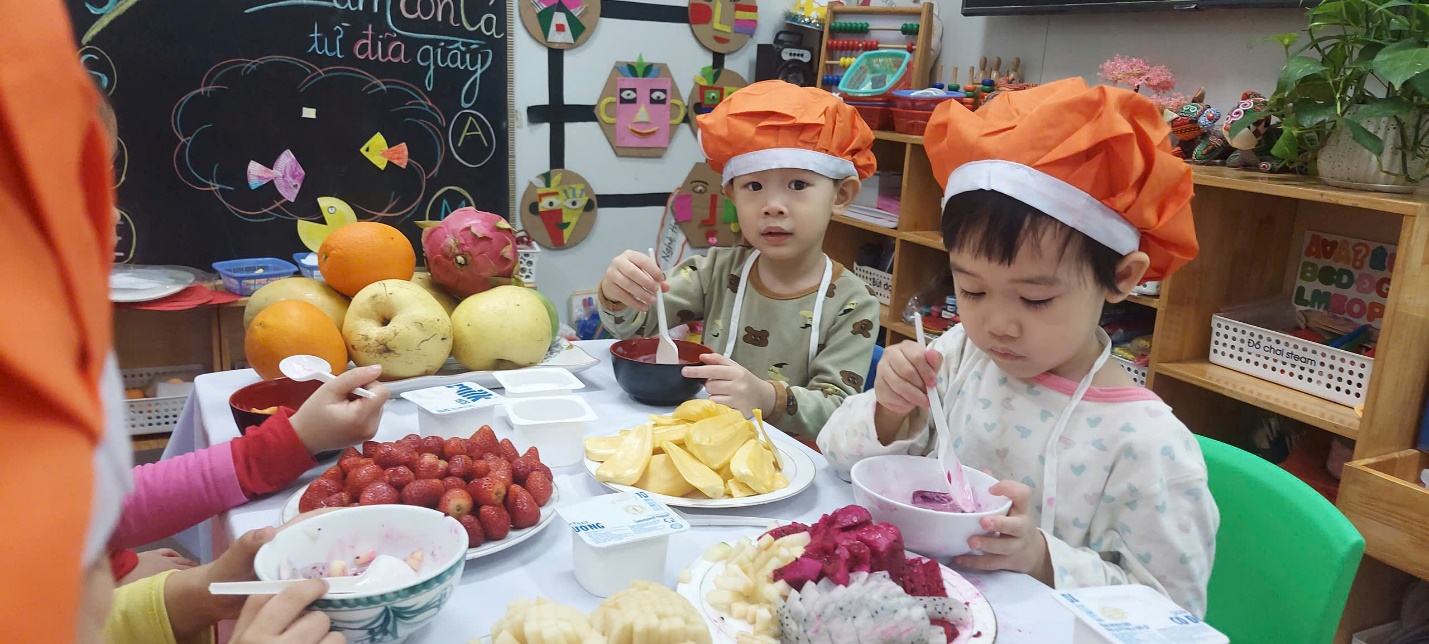 Two children sitting at a table with food
AI-generated content may be incorrect.