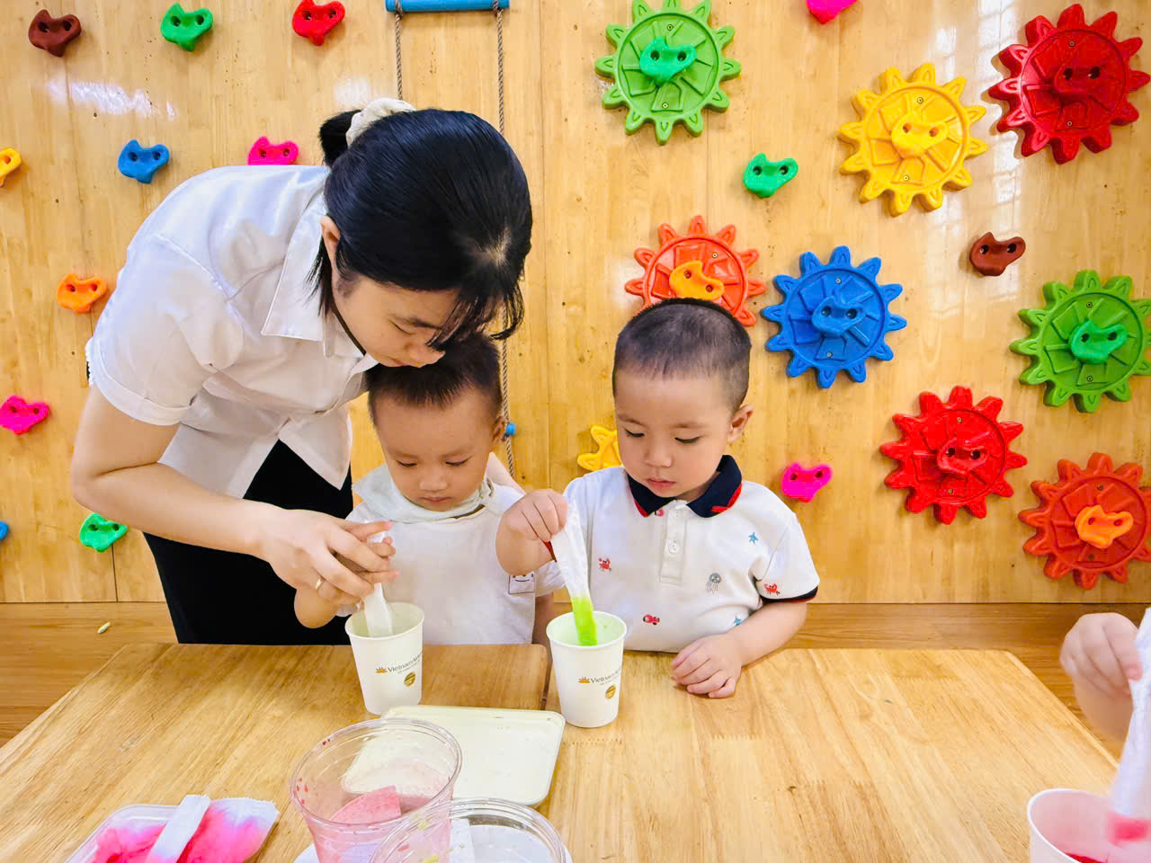 A person and two children sitting at a table
AI-generated content may be incorrect.