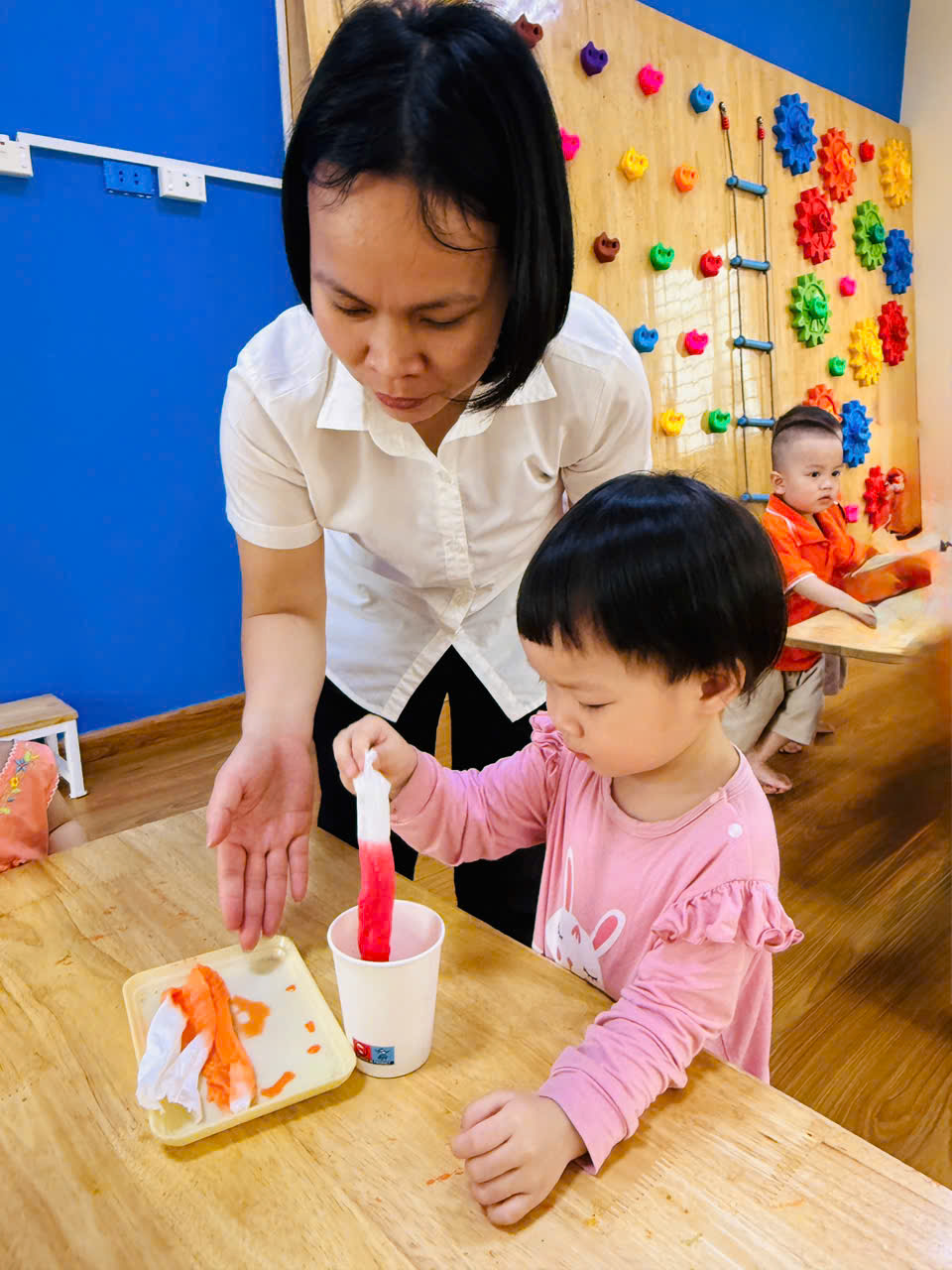 A person and child sitting at a table
AI-generated content may be incorrect.