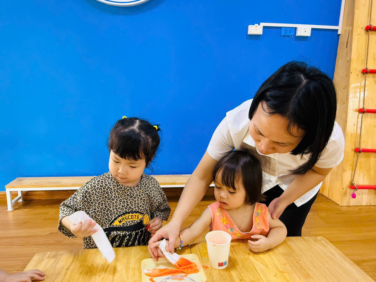 A person and two children sitting at a table
AI-generated content may be incorrect.