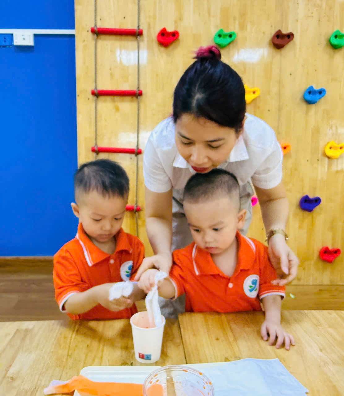 A person and two kids sitting at a table
AI-generated content may be incorrect.