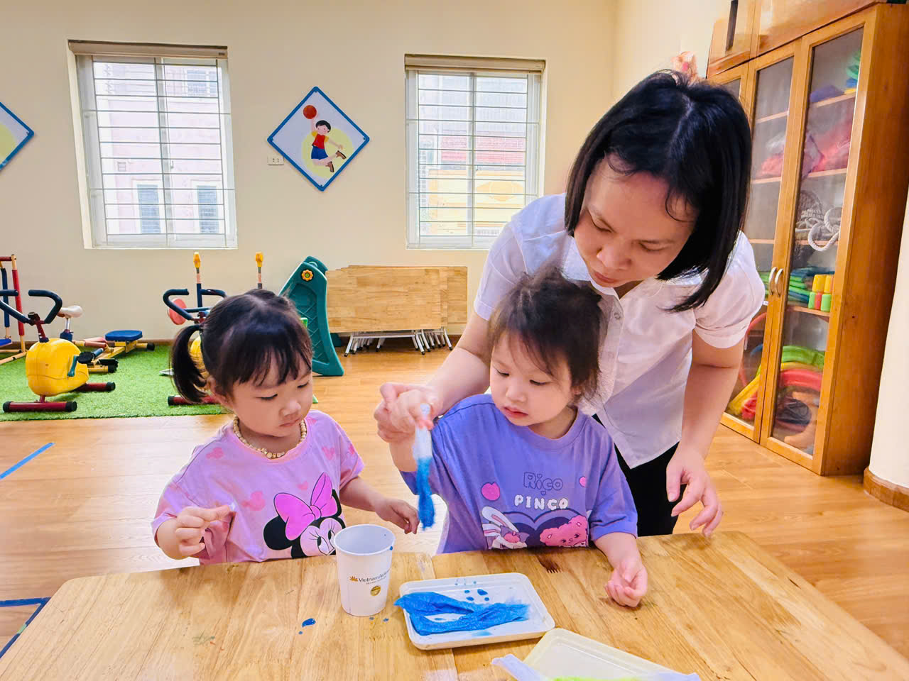 A person and two girls painting
AI-generated content may be incorrect.