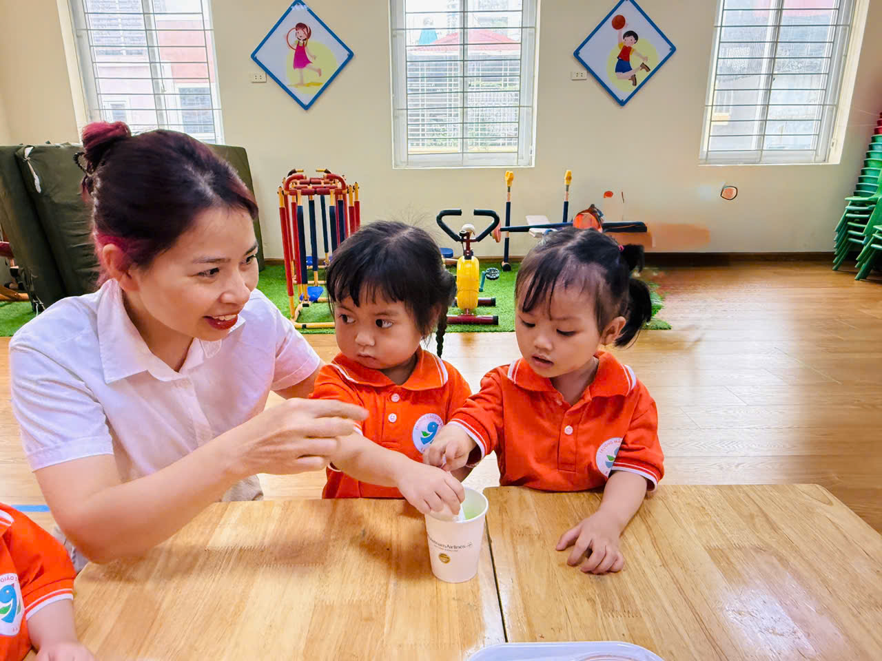 A person and two children sitting at a table
AI-generated content may be incorrect.