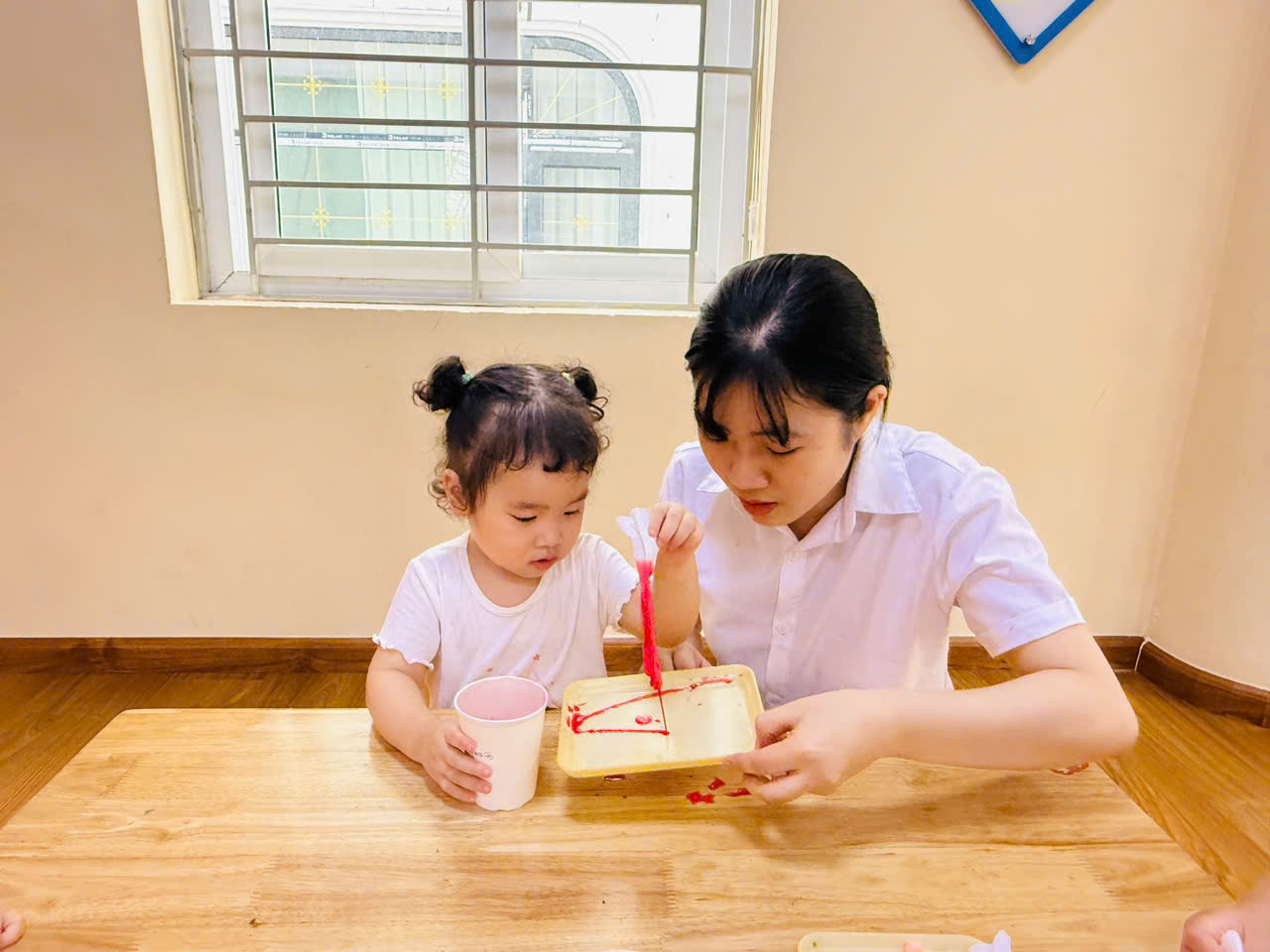 A person and a child painting
AI-generated content may be incorrect.